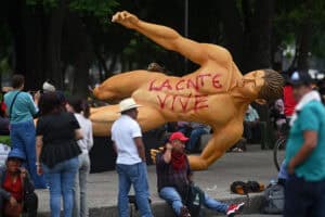 People gather around a giant sculpture alluding to the FIFA 2026 World Cup