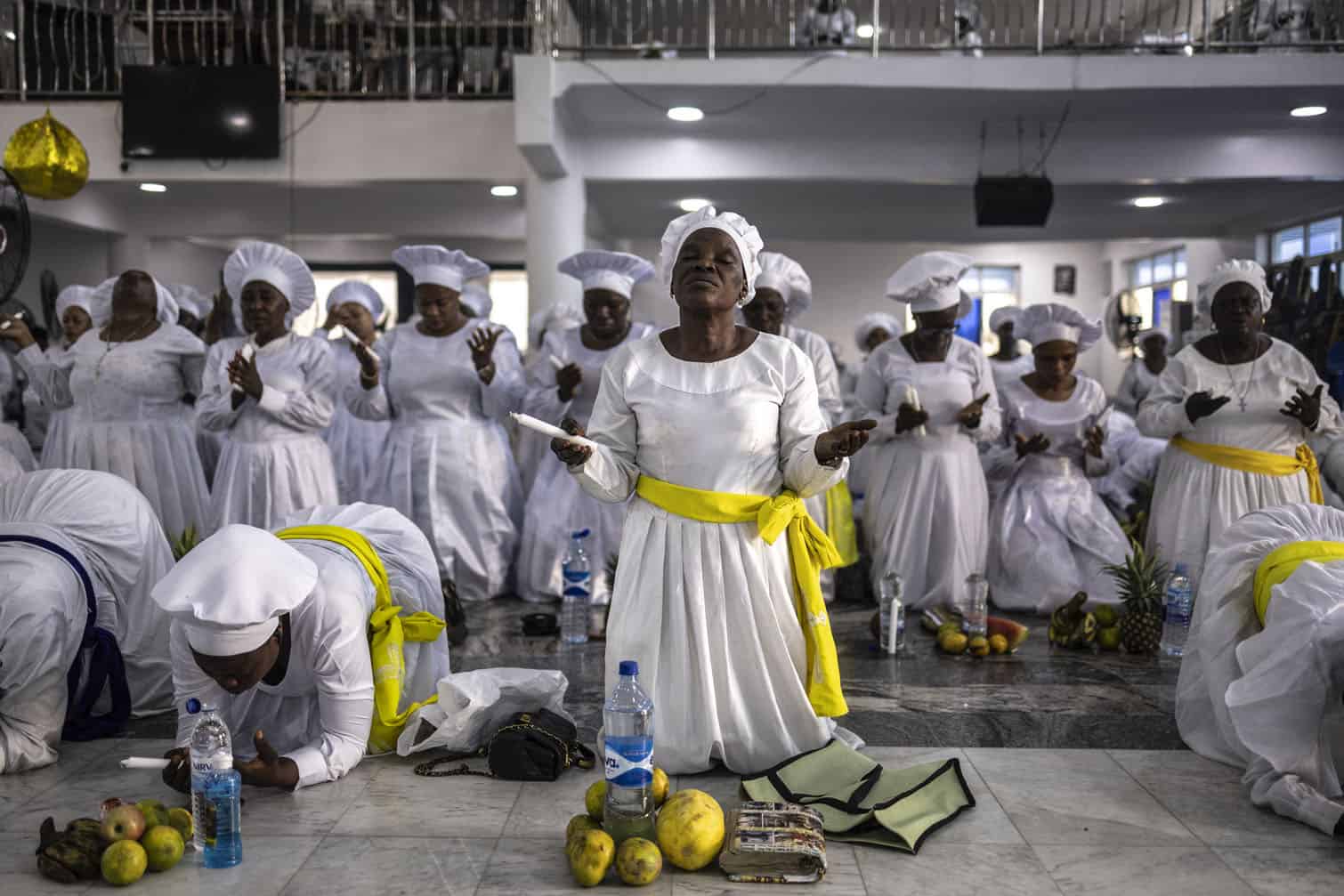 A worshipper kneels in prayer