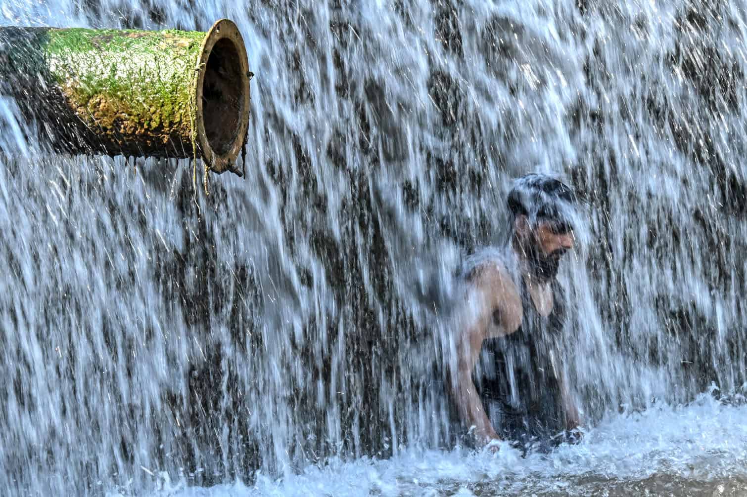 A man cools off in stream water