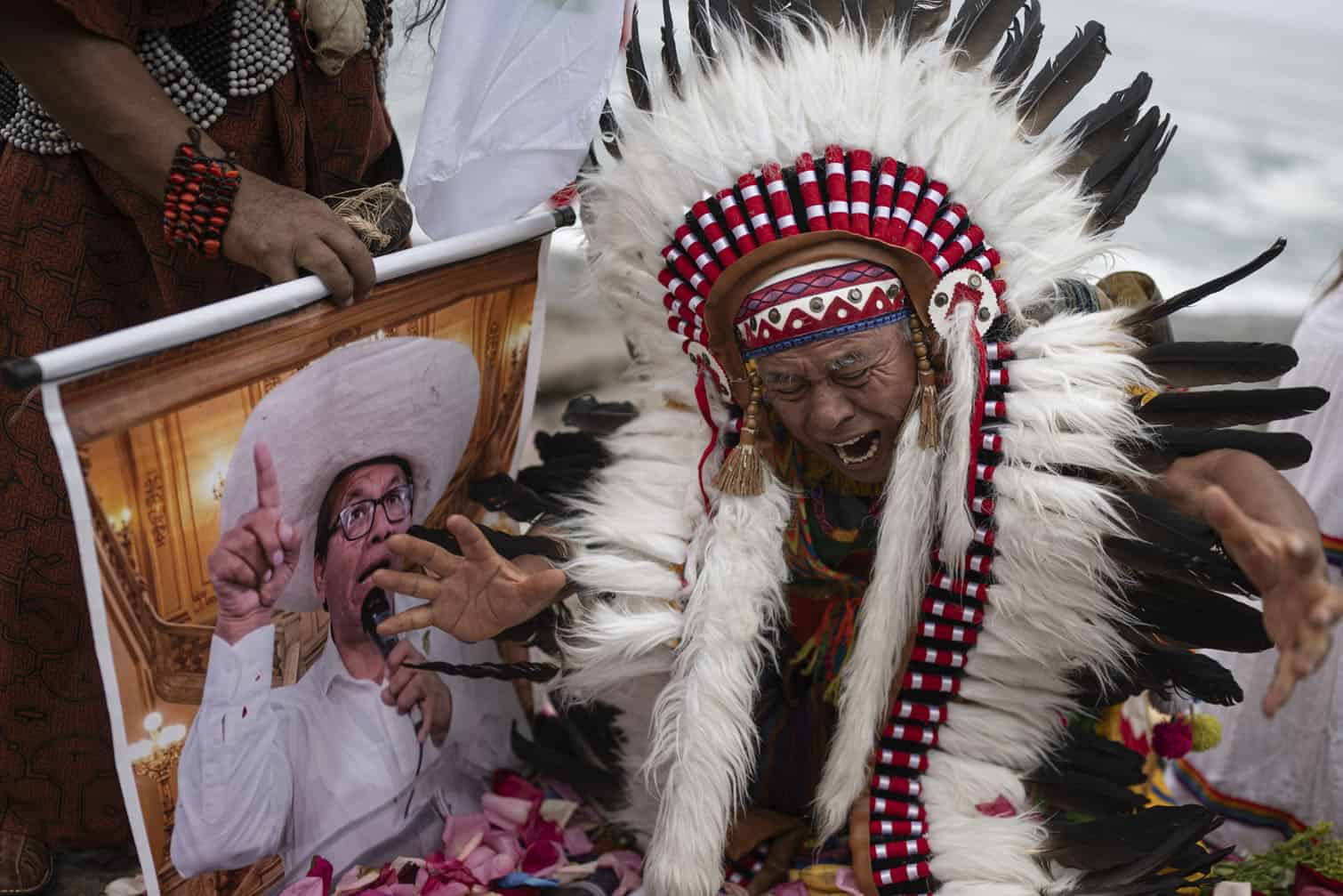 Shamans hold a poster of presidential candidate Roberto Sanchez