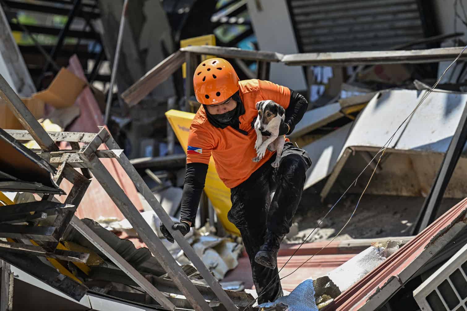 A responder carries a rescue dog