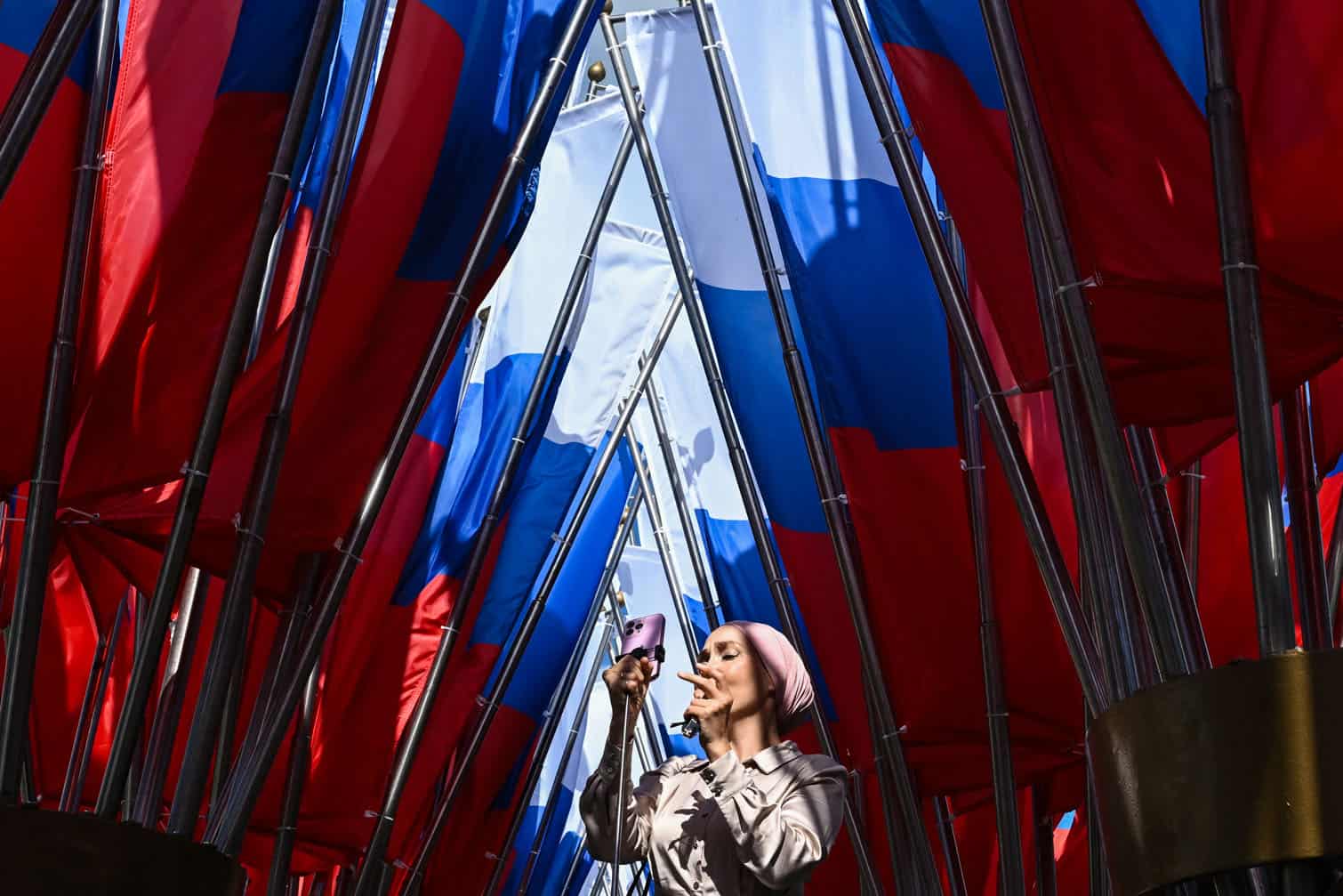 A woman takes a picture in Manezhnaya square