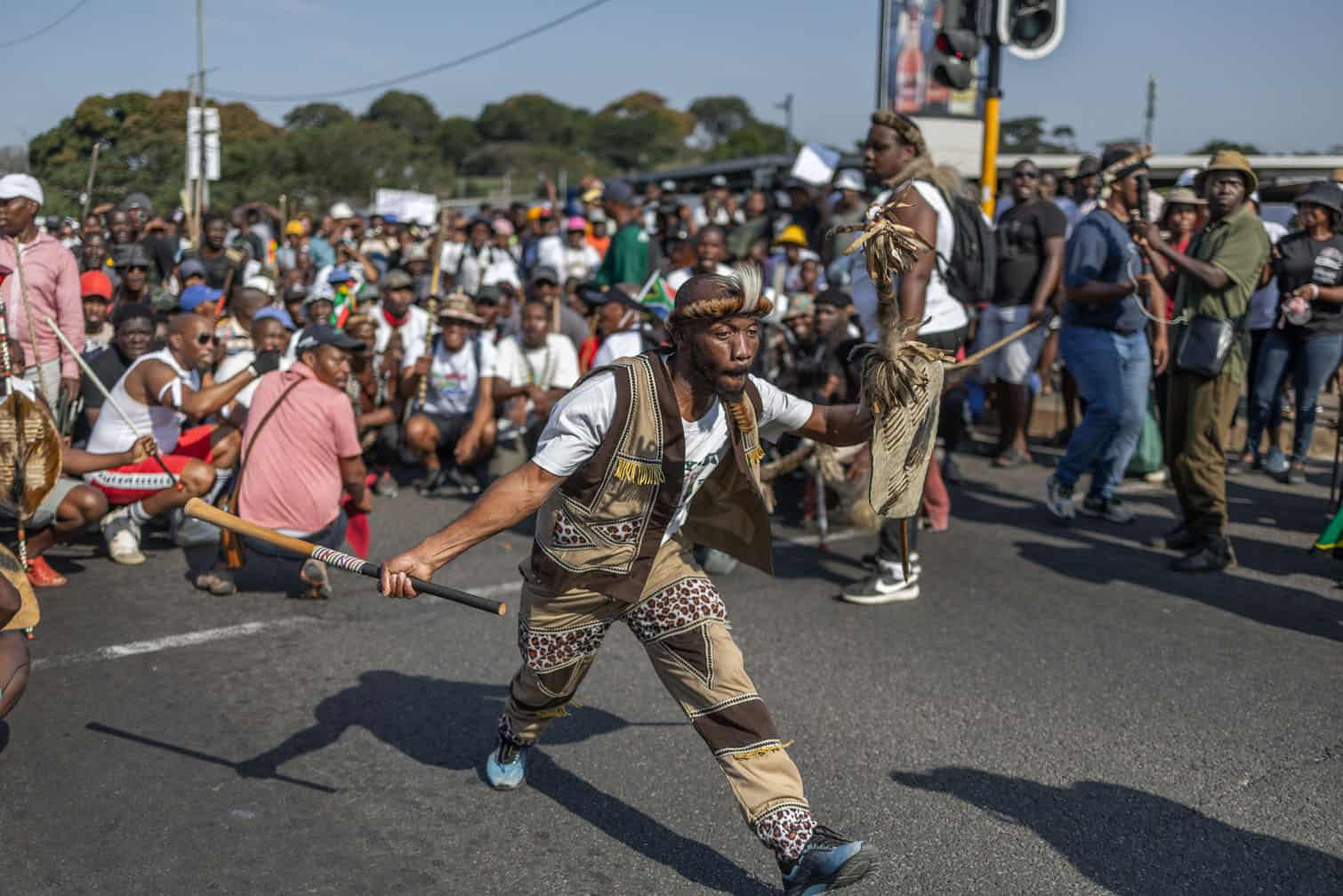 A protester dressed in a traditional Zulu attire gestures during a protest