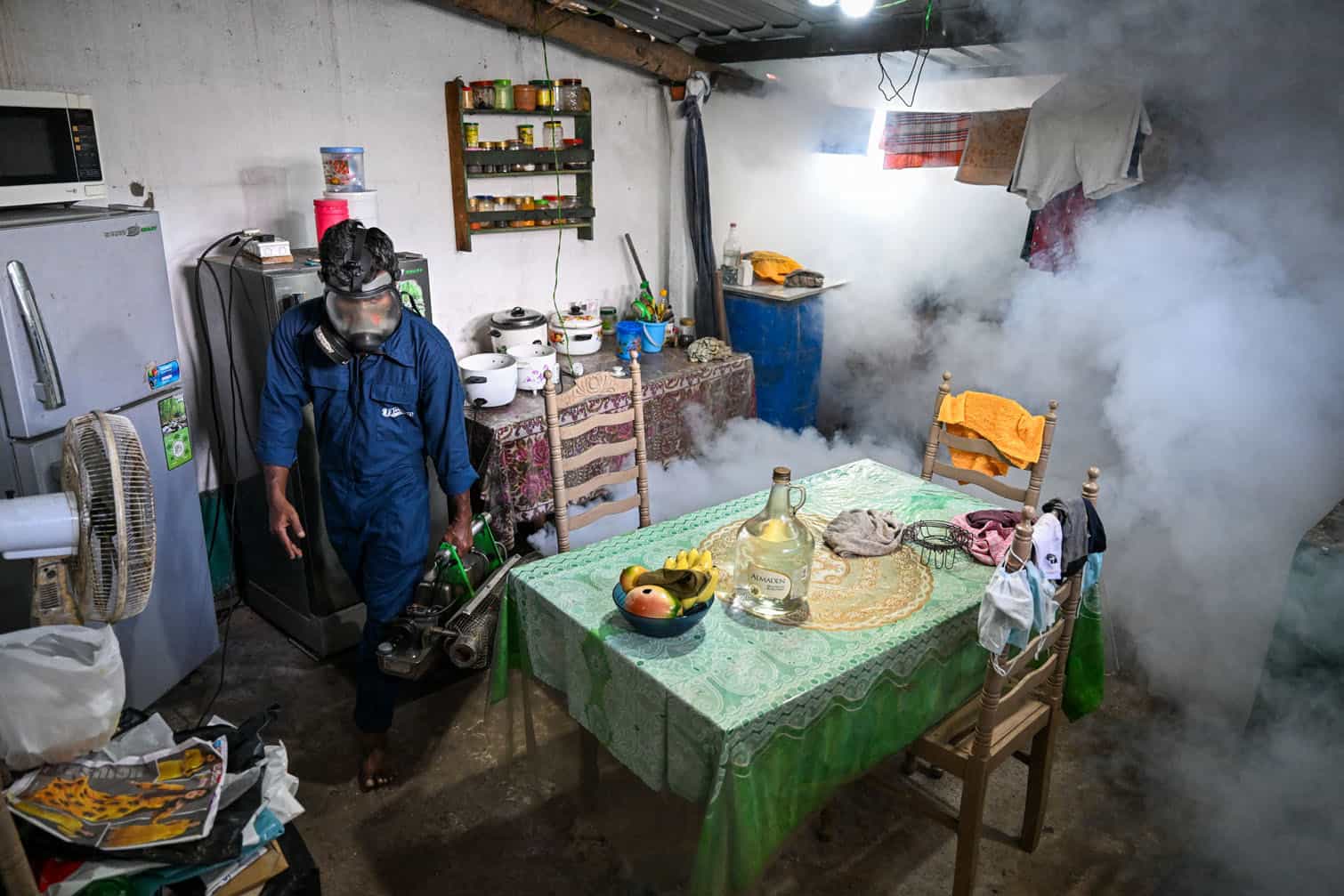 A municipal worker fumigates a house