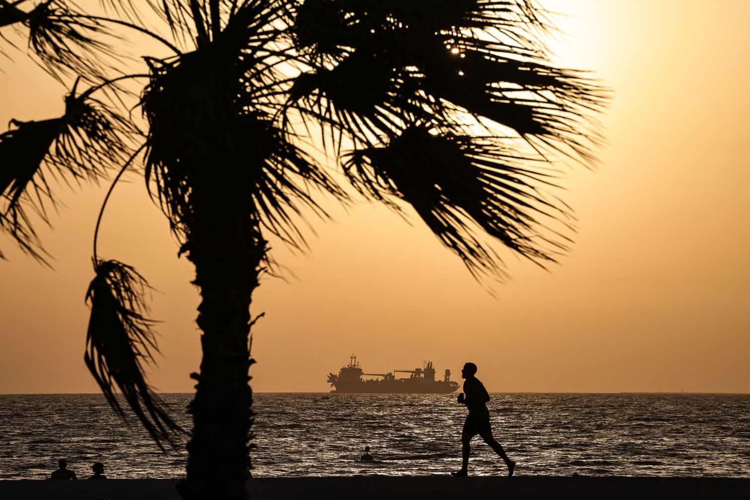 A man runs on the beach