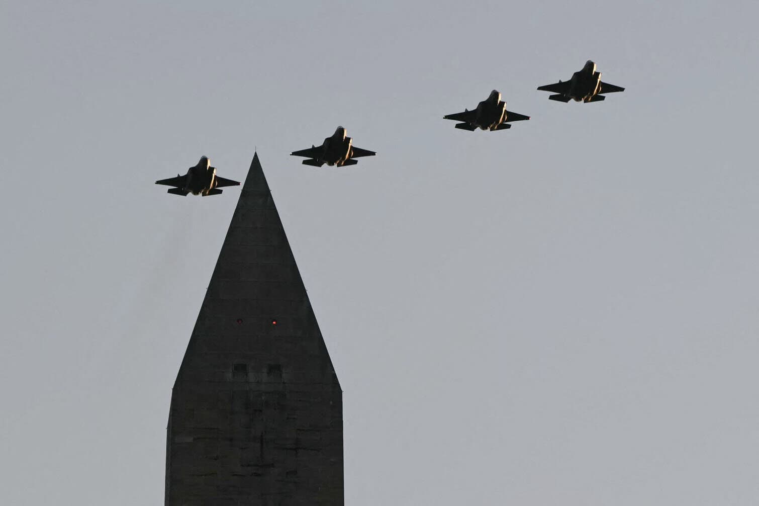 Four F-35s fly over the Washington Memorial
