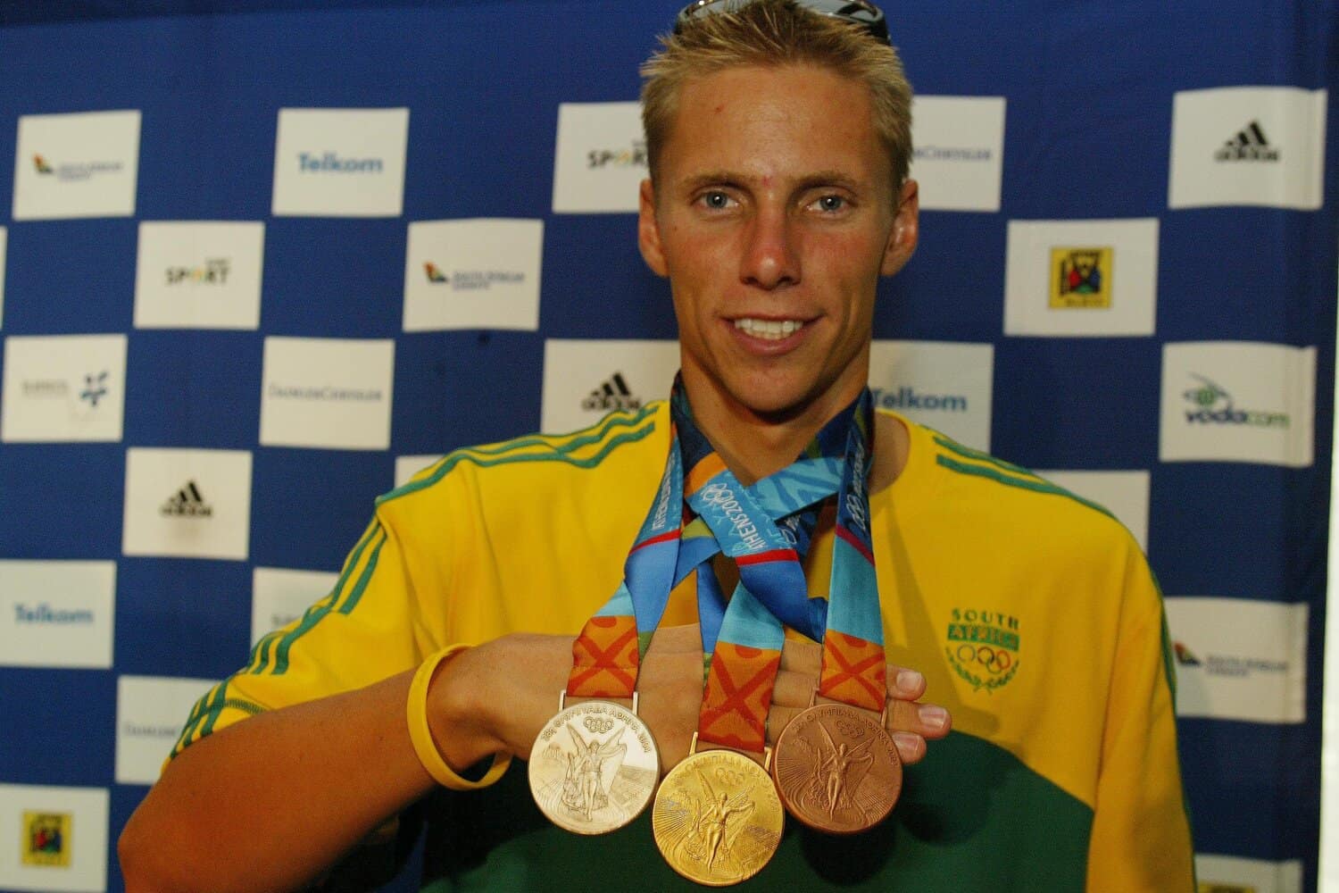 Roland Schoeman shows off his gold, silver and bronze medals from Athens. Picture: Duif du Toit / Gallo Images