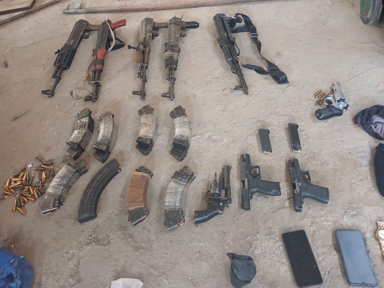 Suspect arrested after cops recover nine unlicensed firearms and stolen vehicles [PICTURES]