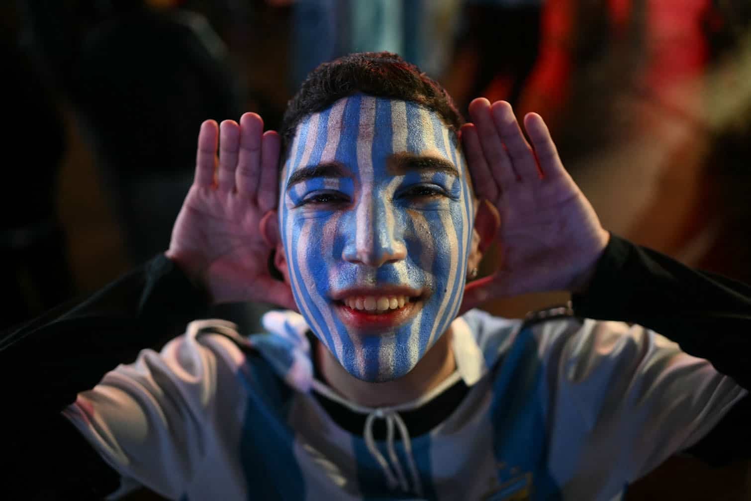 An Argentina supporter with blue-and-white face paint