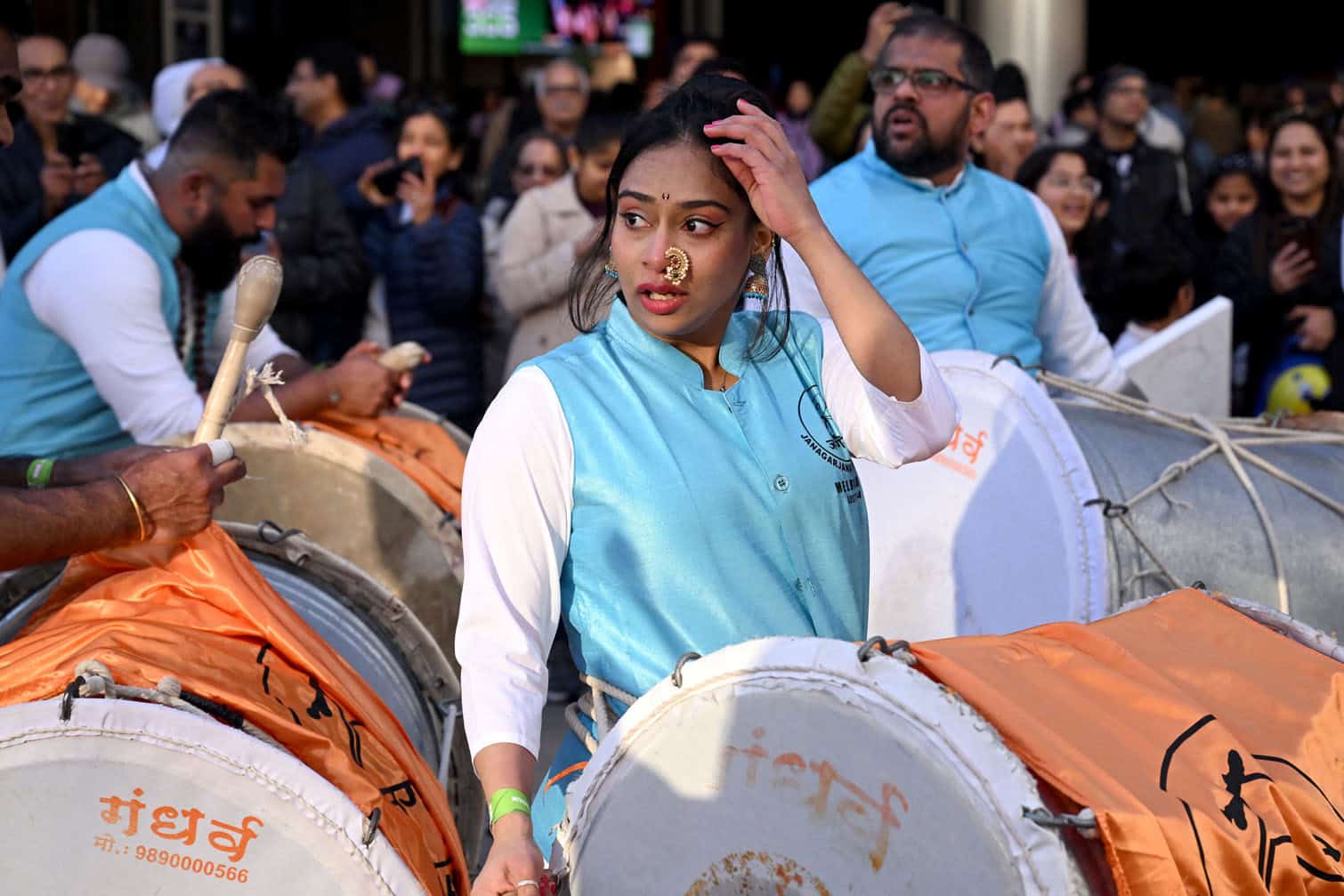 Performers prepare to play drums