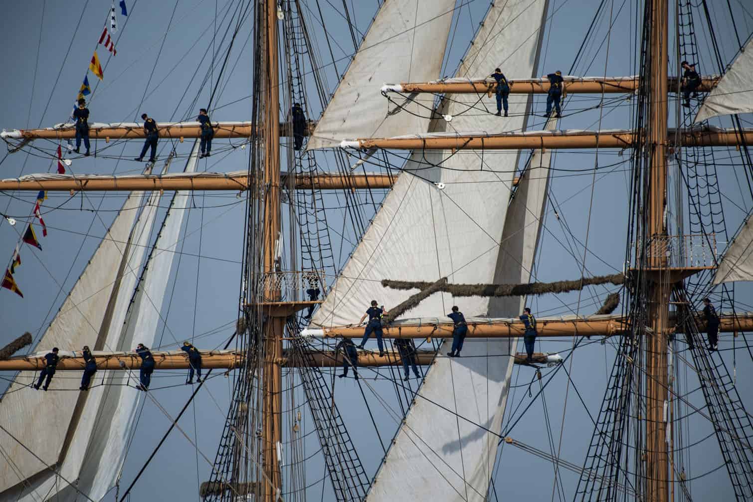 Crew on the USCGC Eagle climb the rigging