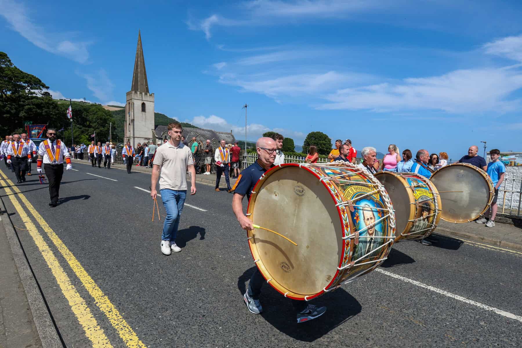 Orange men carrying Lambeg drums