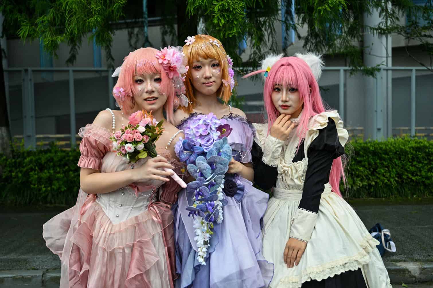 Cosplayers pose for pictures