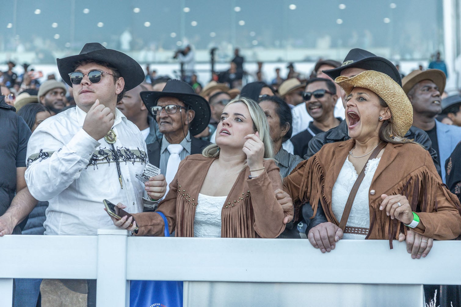 Racegoers react as they watch a race