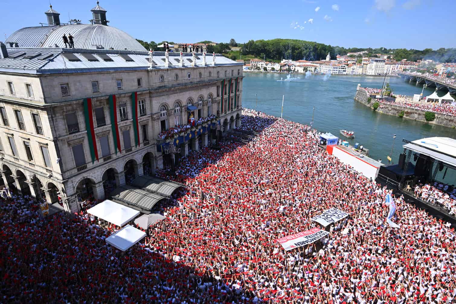 Attendees wave traditionnal Bayonne festival red scarfs