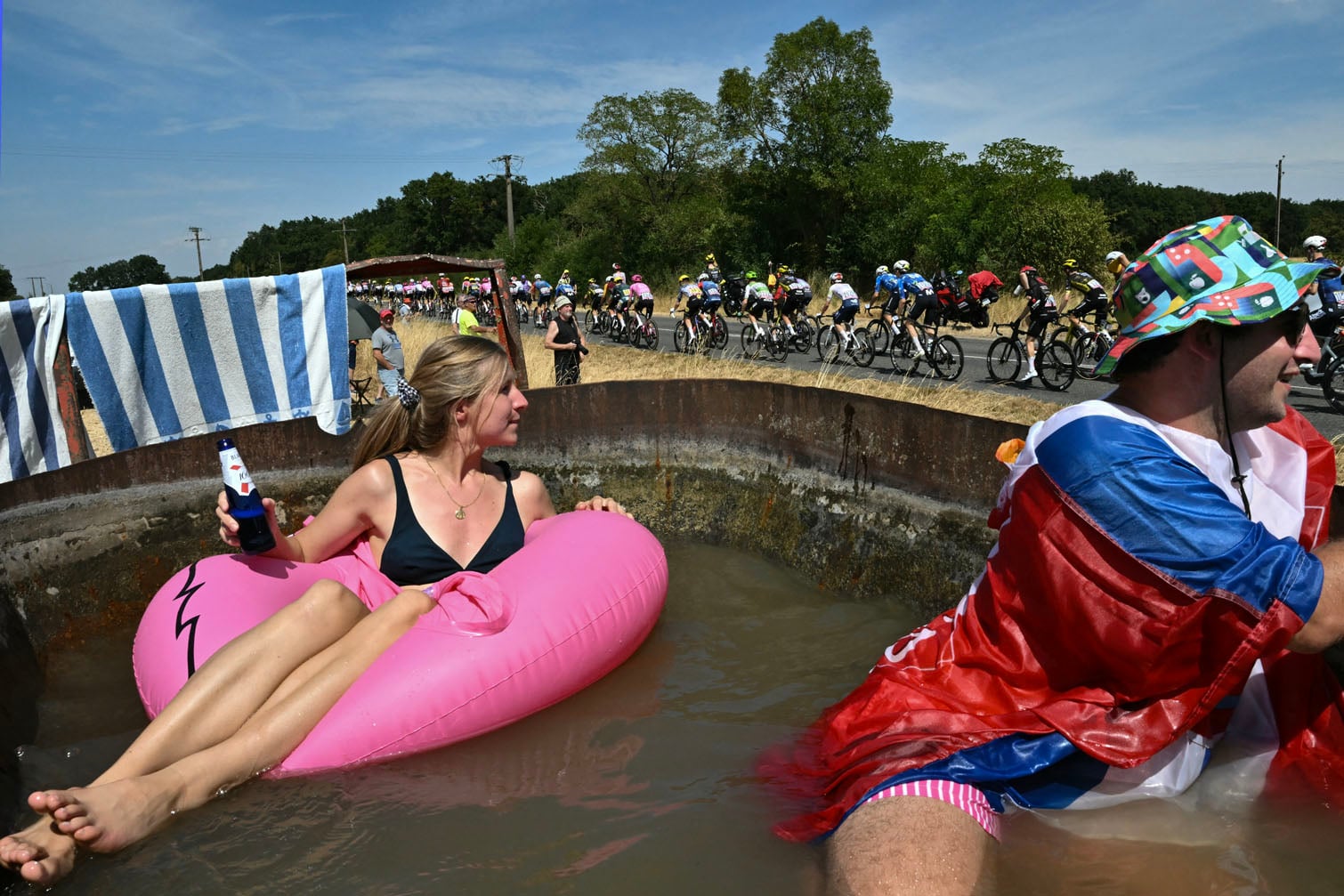 Spectators sit in a makeshift pool of water