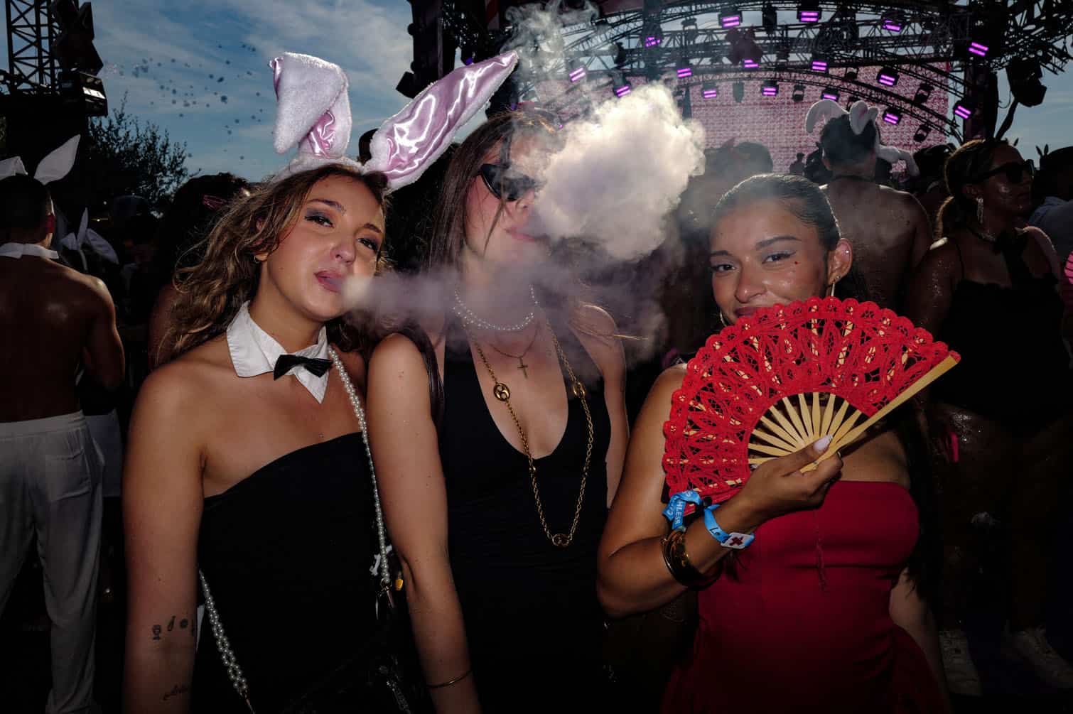 People pose as they arrive to attend the 