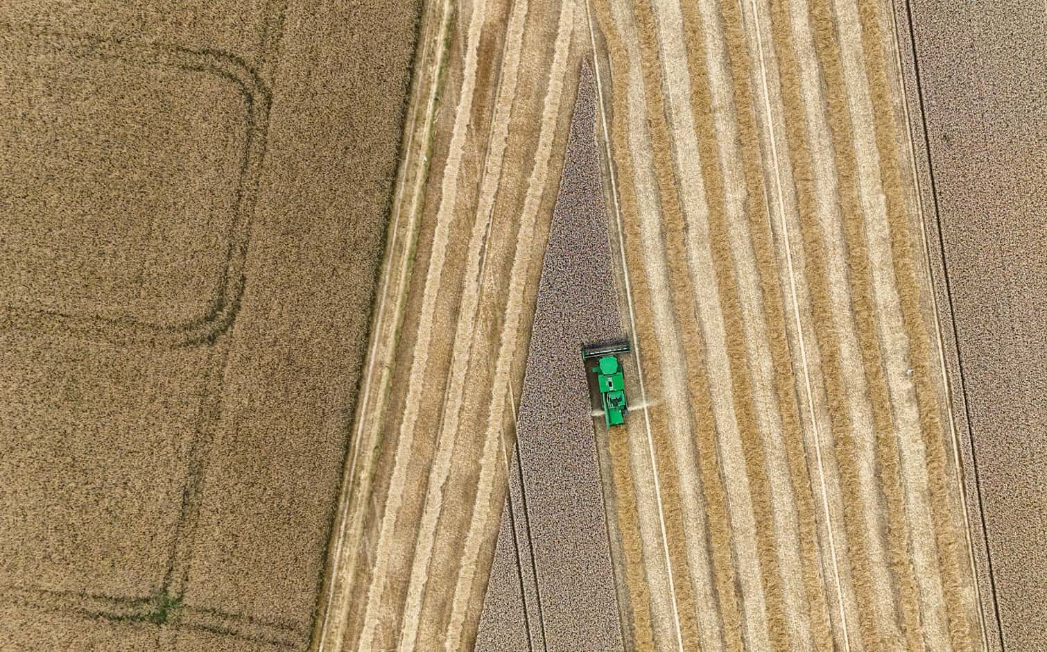 An aerial view shows a combine harvester