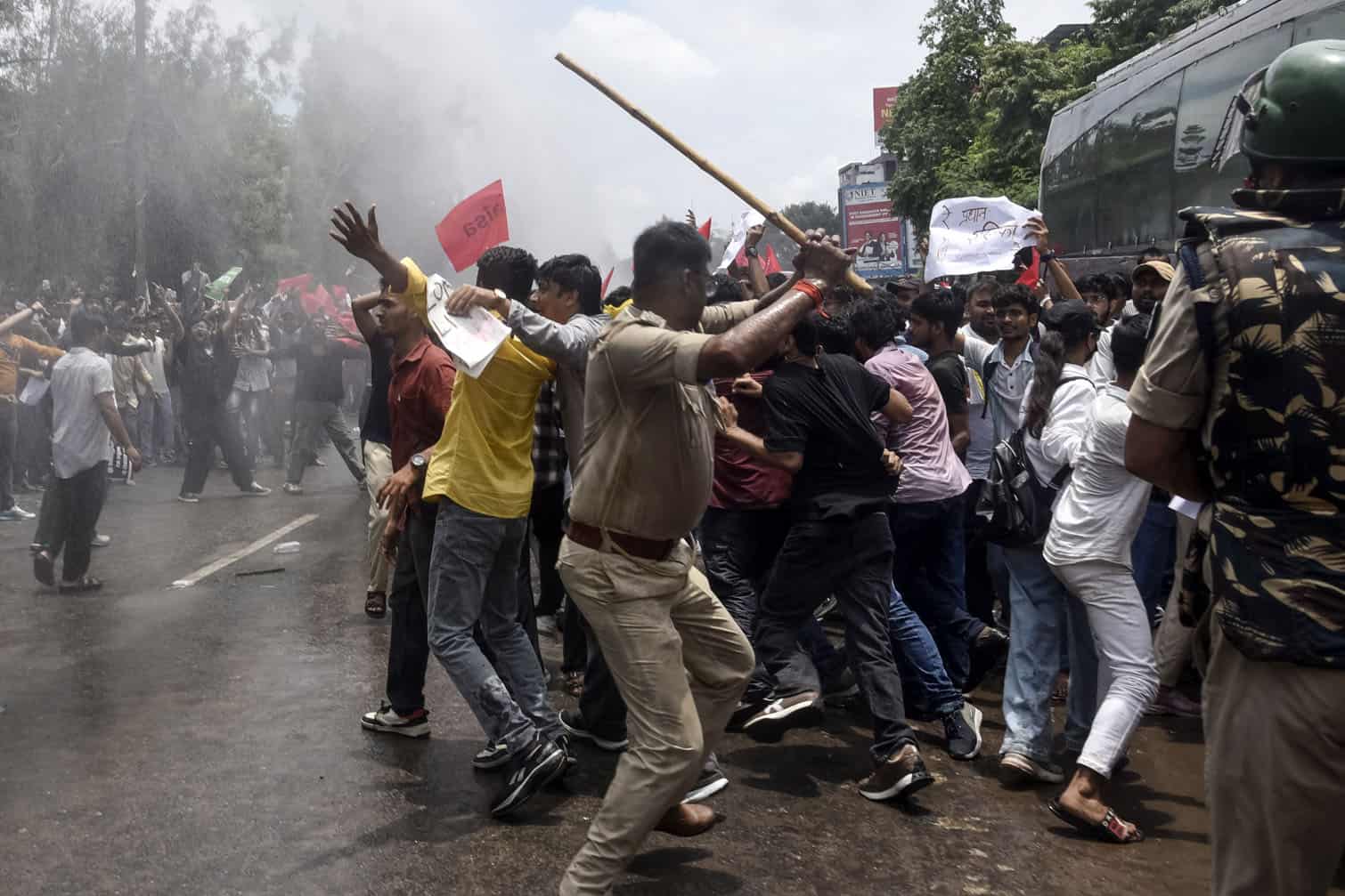 Police personnel use batons