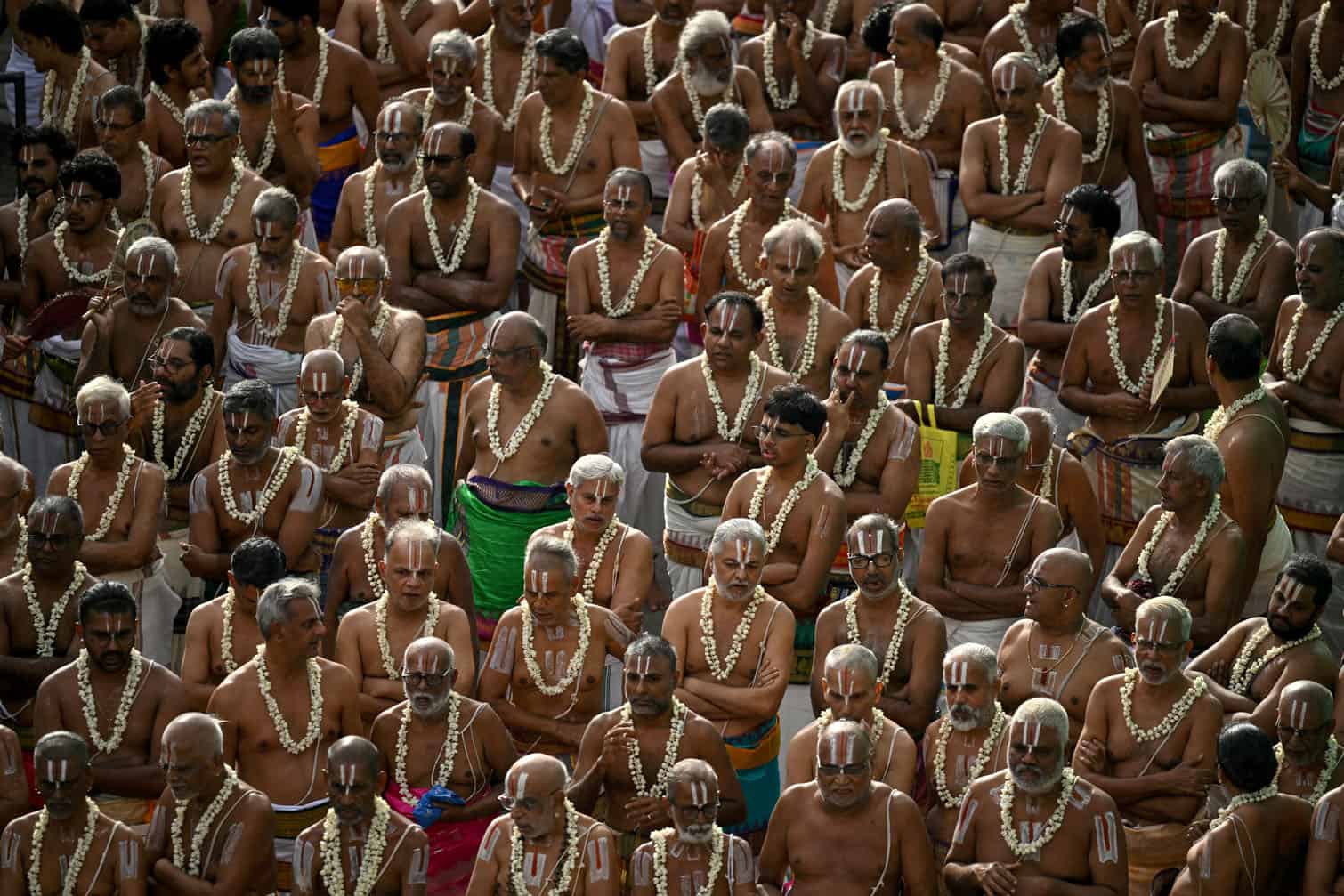 A group of priests take part by chanting mantras