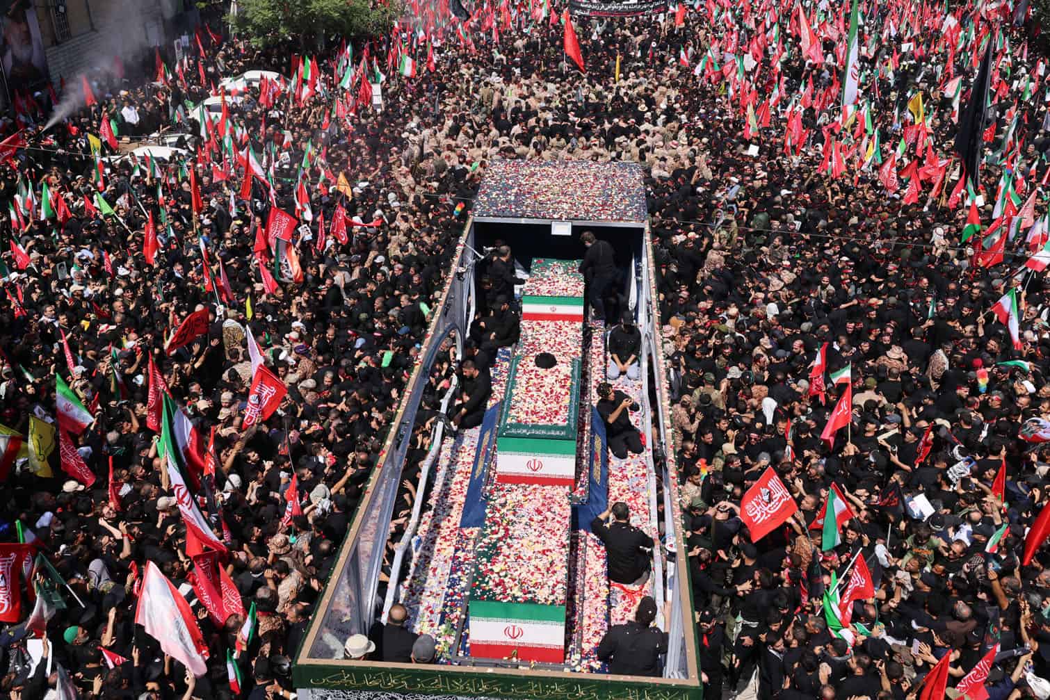 Flower petals are thrown on the coffins