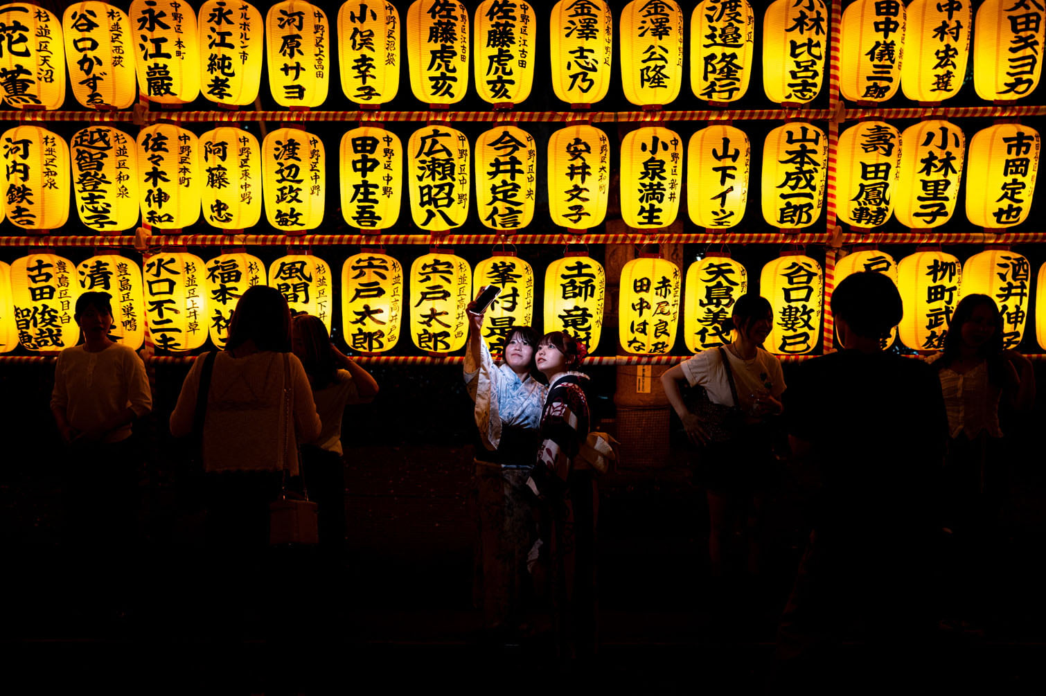 People gather in front of thousands of lanterns