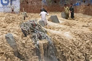 Residents wade through floodwater following heavy monsoon rains