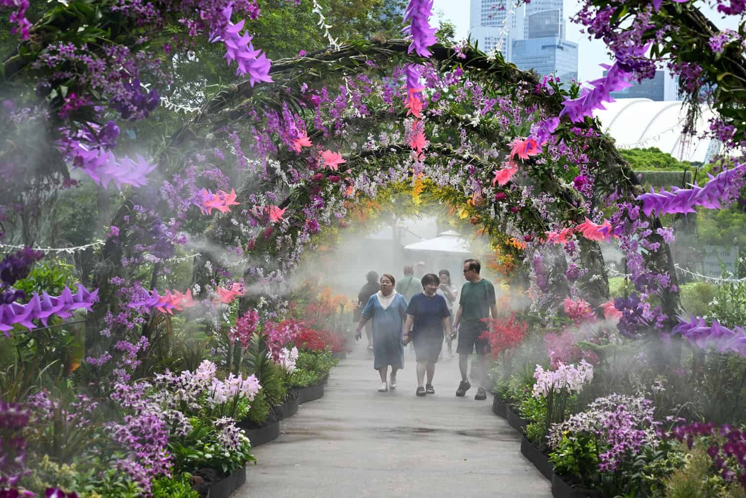 Visitors walk along the floral garden display