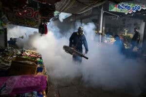 A municipal worker fumigates a market