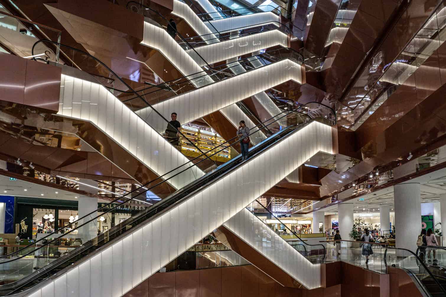 People ride escalators as they visit Dusit Central Park mall
