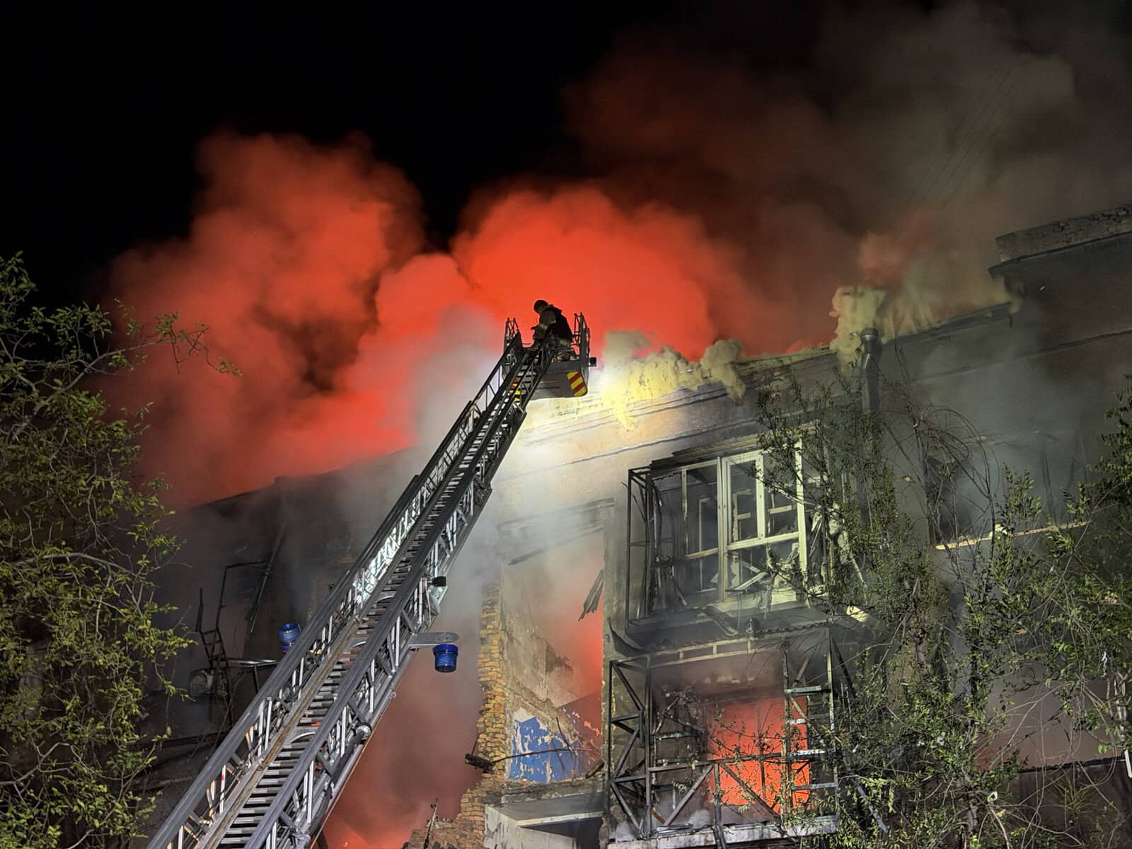 Ukrainian rescuers work to extinguish a fire