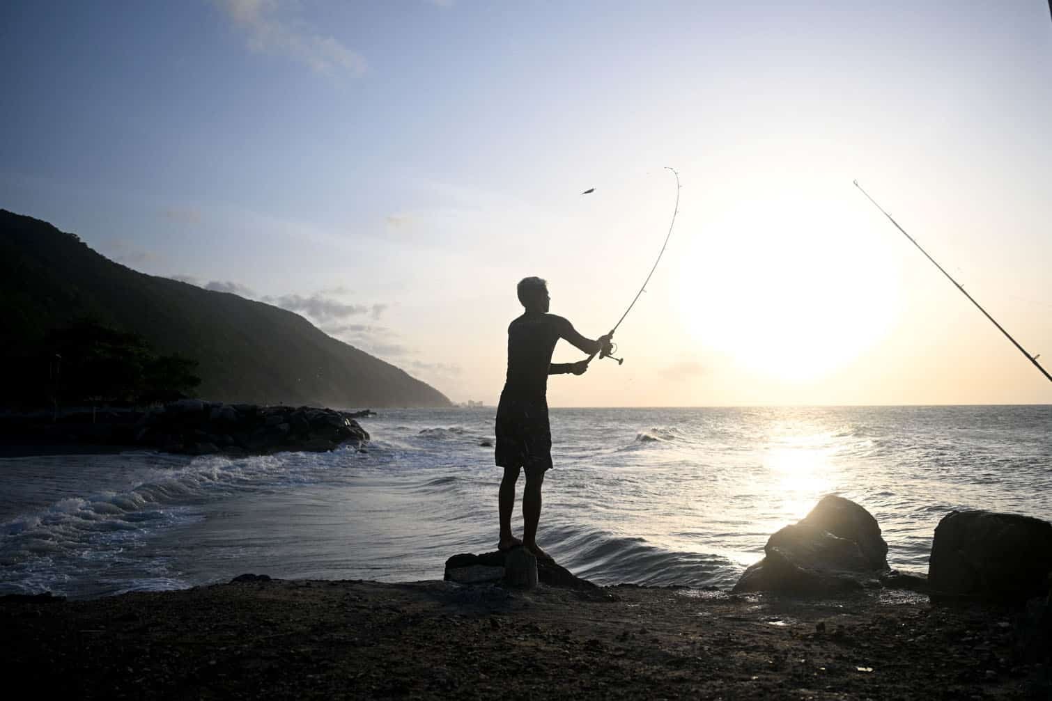 A man fishes at sunset in Anare