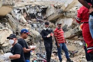 Workers and residents remove debris