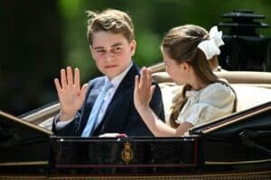 Britain's Prince George of Wales (L) and Britain's Princess Charlotte of Wales wave as they make their way back to Buckingham Palace from the Horse Guards Parade during the King's Birthday Parade "Trooping the Colour" in London on June 13, 2026. The UK's Prince George, second in line to the throne, turned 13 on July 22, 2026 as he readied to follow in his father Prince William's footsteps and start at the prestigious Eton College. Picture JUSTIN TALLIS / AFP