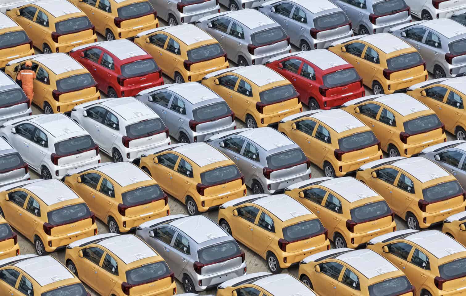 South Korean-made Kia Picanto cars are seen awaiting shipment at a vehicle storage yard in Yantai, in eastern China's Shandong province, on August 10, 2026. (Photo by CN-STR / AFP)