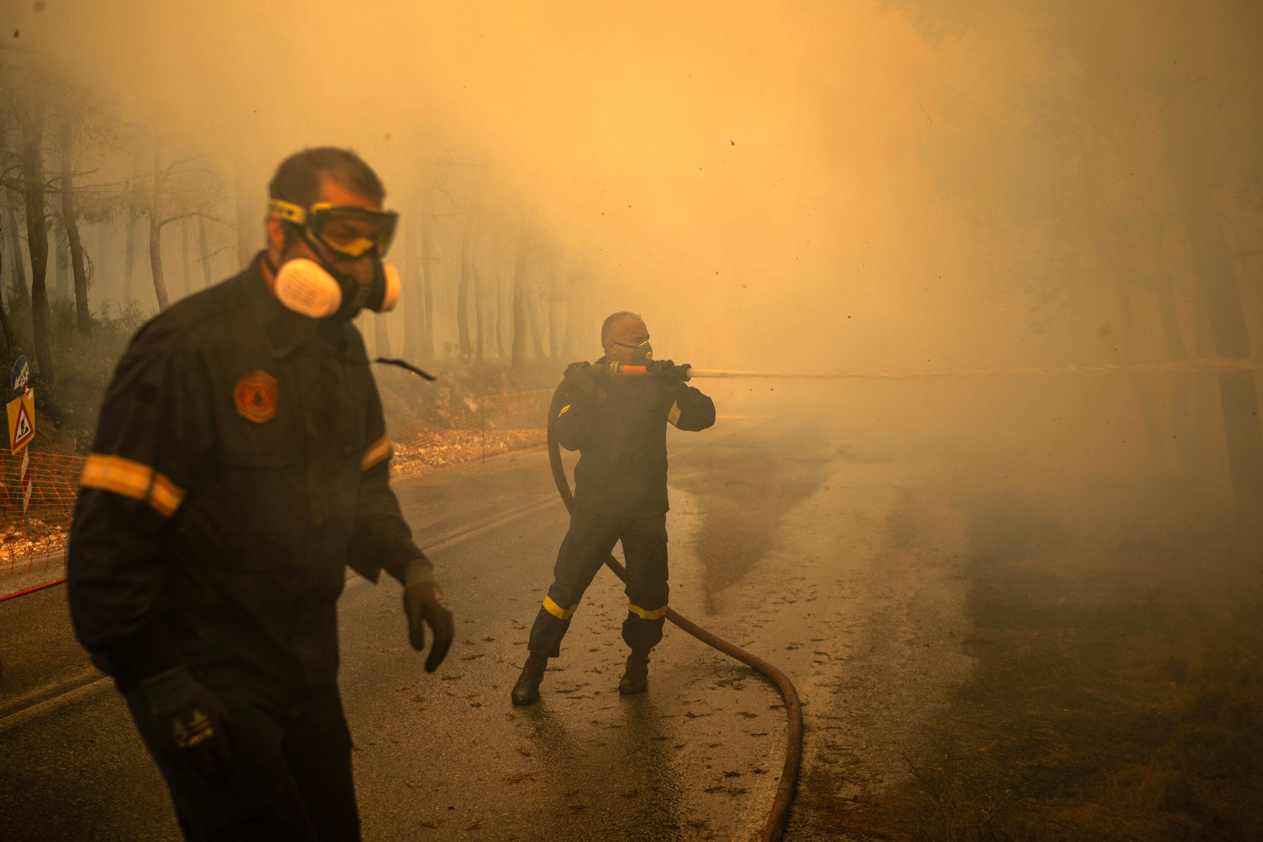 Greek firefighters try to extinguish a wildfire in the area of Porto Germeno, some 70 kilometres (45 miles) northwest of Athens in the region of Viotia, on August 2, 2026. Greece on August 2, 2026, faced multiple fronts and a growing damage toll after a week of wildfires devastated over 12,000 hectares of forest and agricultural land, experts said. Porto Germeno and other villages were evacuated when the fire broke out on July 31, but local authorities say scores of homes were damaged or destroyed. Hit hard by the climate crisis like the rest of the Mediterranean region, the country is plagued by wildfires every summer due to high temperatures, frequent heatwaves, and drought. (Photo by Angelos TZORTZINIS / AFP)