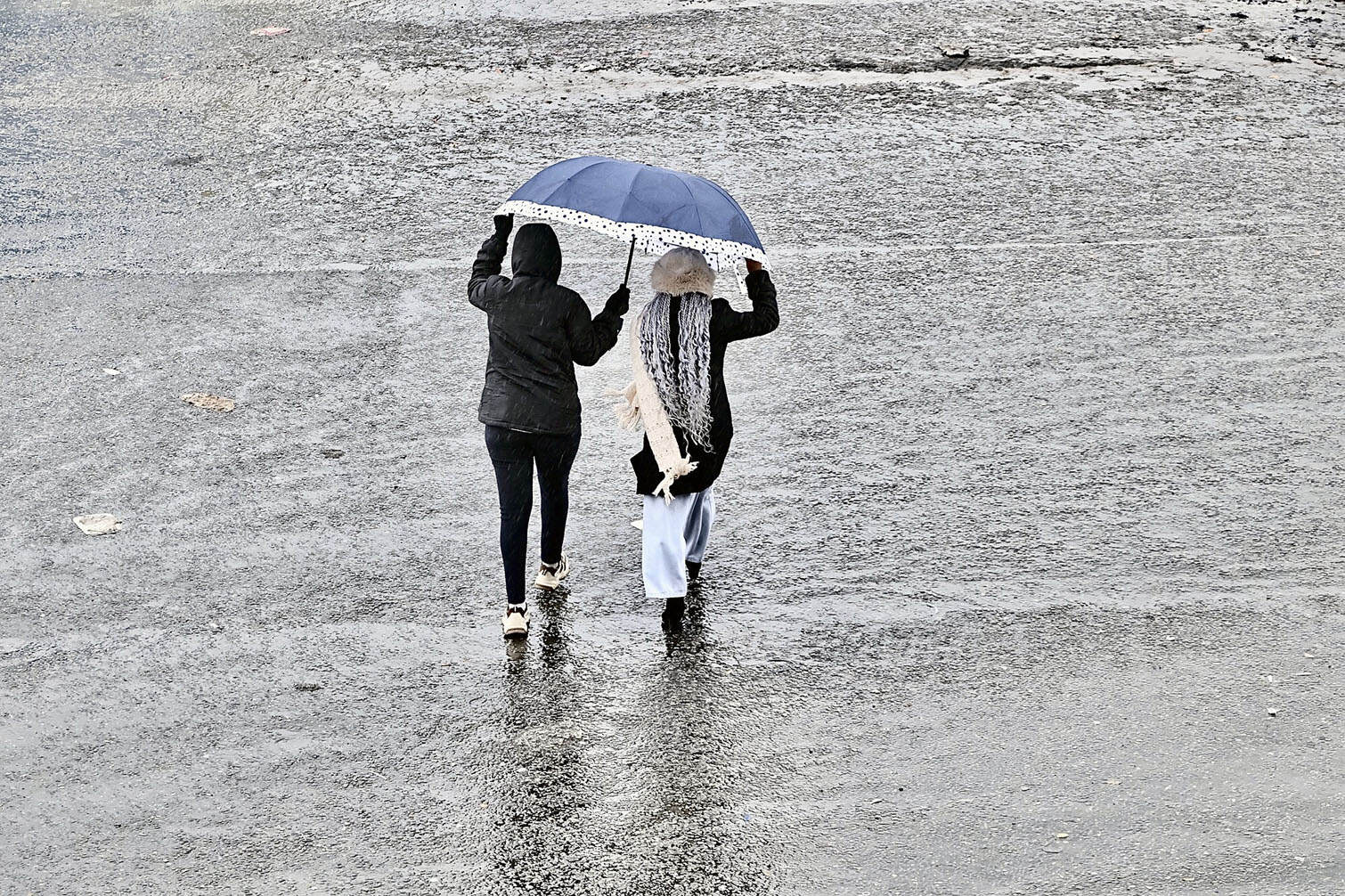 Soweto residents use umbrellas for protection from the cold front at Bara Taxi Rank in Soweto on 11 August 2026. Picture: Jessica Nkuna