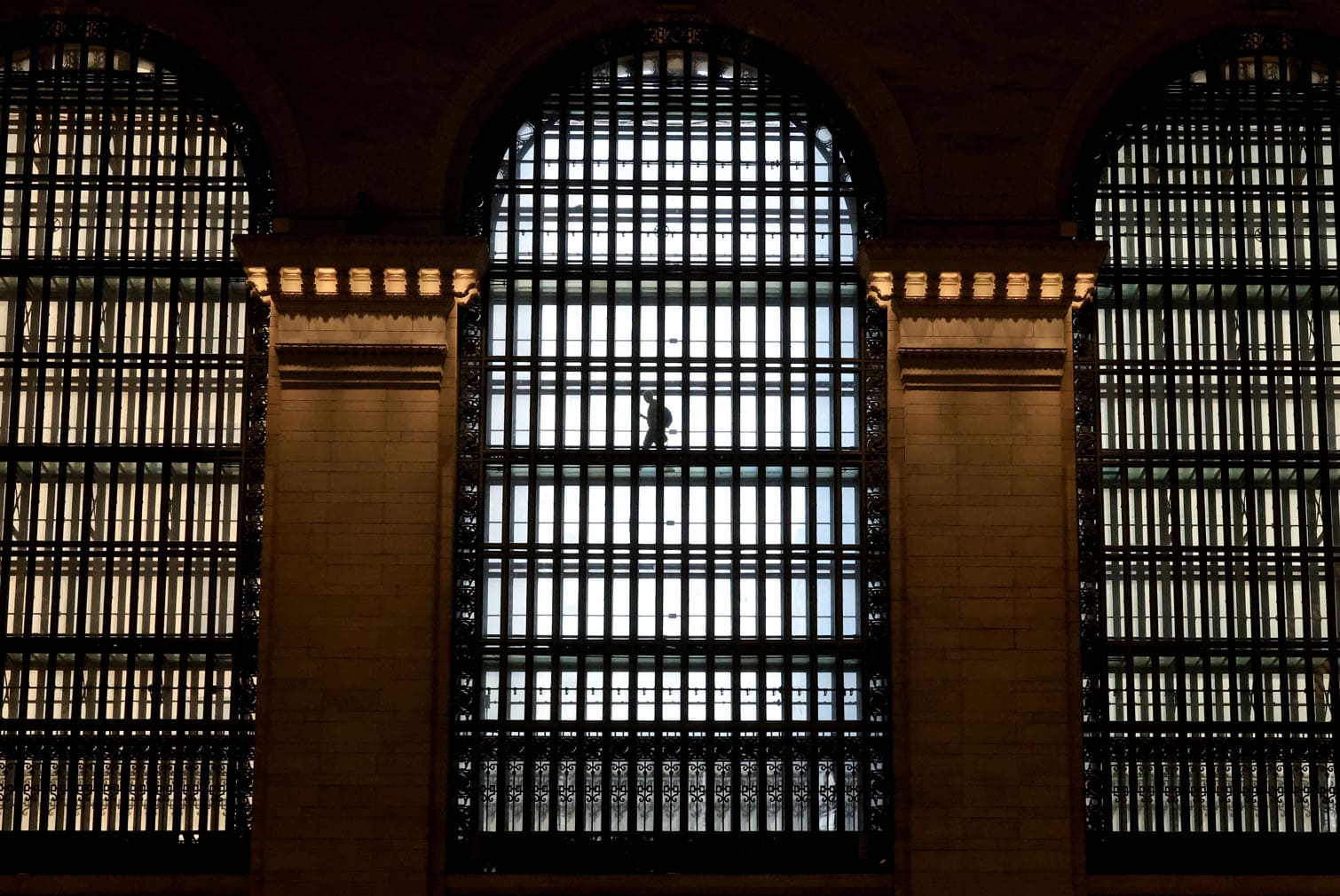 A person walks past the Grand Central Terminal six-story arched Palladian windows on the east of the Main Concourse, in New York, on August 10, 2026. (Photo by TIMOTHY A. CLARY / AFP)