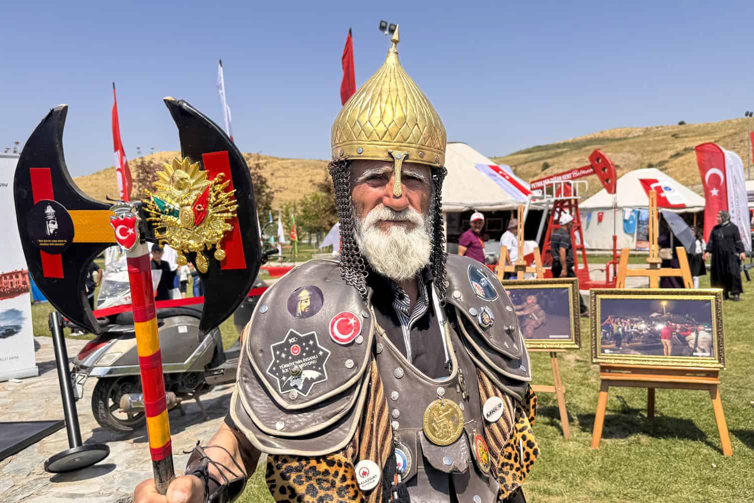 Hasan Keskin, 72, poses in a symbolic warrior costume while holding a ceremonial battle axe during events marking the 955th anniversary of the Malazgirt Victory, (Battle of Manzikert), on August 24, 2026 in Ahlat, Bitlis, Turkiye. The 1071 Battle of Manzikert is regarded as a major turning point in Anatolian history, paving the way for increased Turkic settlement in the region following the Seljuk victory over the Byzantine Empire. Keskin, who traveled from the Tavas district of Denizli, completed his military service in Malazgirt, Mus, in 1974 and has since sought to keep alive his admiration for Sultan Alparslan and the spirit associated with the historic victory. (Photo by Ozkan Bilgin/Anadolu via Getty Images)