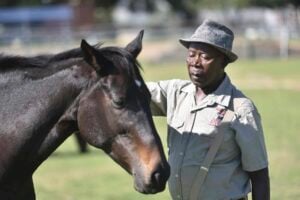 Soweto Equestrian Centre founder Enos Mafokate shows some love to one of his horses. Picture: Nigel Sibanda
