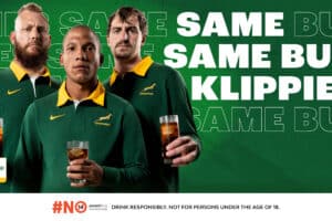 3 man wearing rugby tshirts and holding glasses