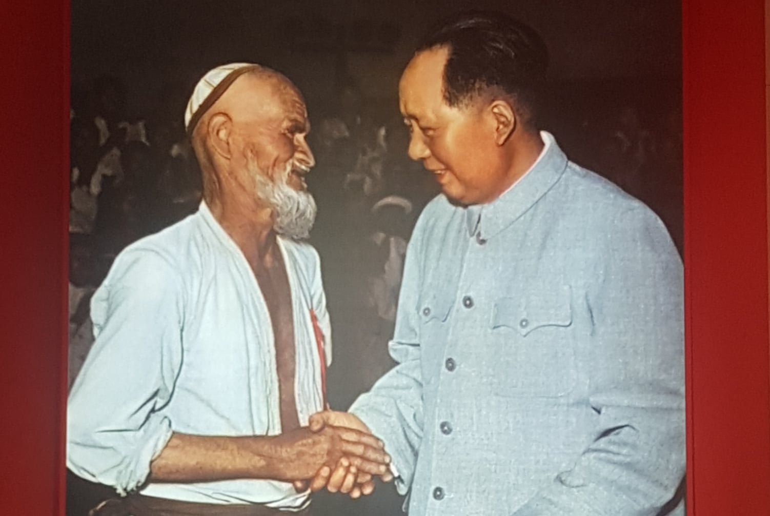 A photo on display in Urumqi's Urban Planning Office of Mao with a Uyghur minority in 1958.