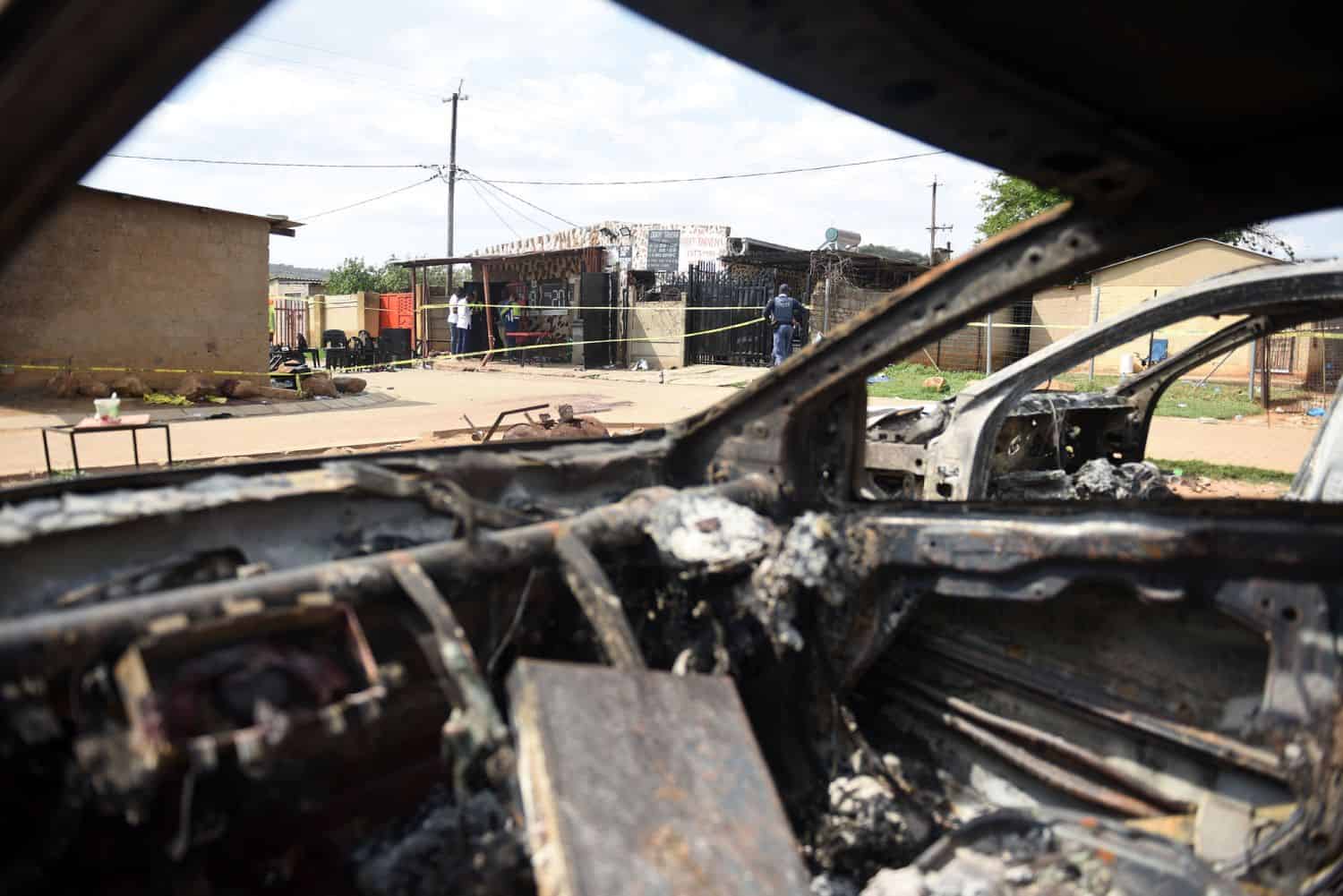 Burnt-out cars next to Dora's tavern in Wedela, on the West Rand, bear testimony to the carnage of the mass shooting. Picture: Nigel Sibanda