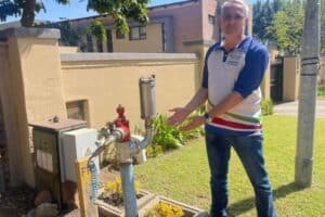 Ward 106 councillor Chris Santana inspects the newly installed air valve in Columbus Crescent, Douglasdale, following another pipe burst in the area.