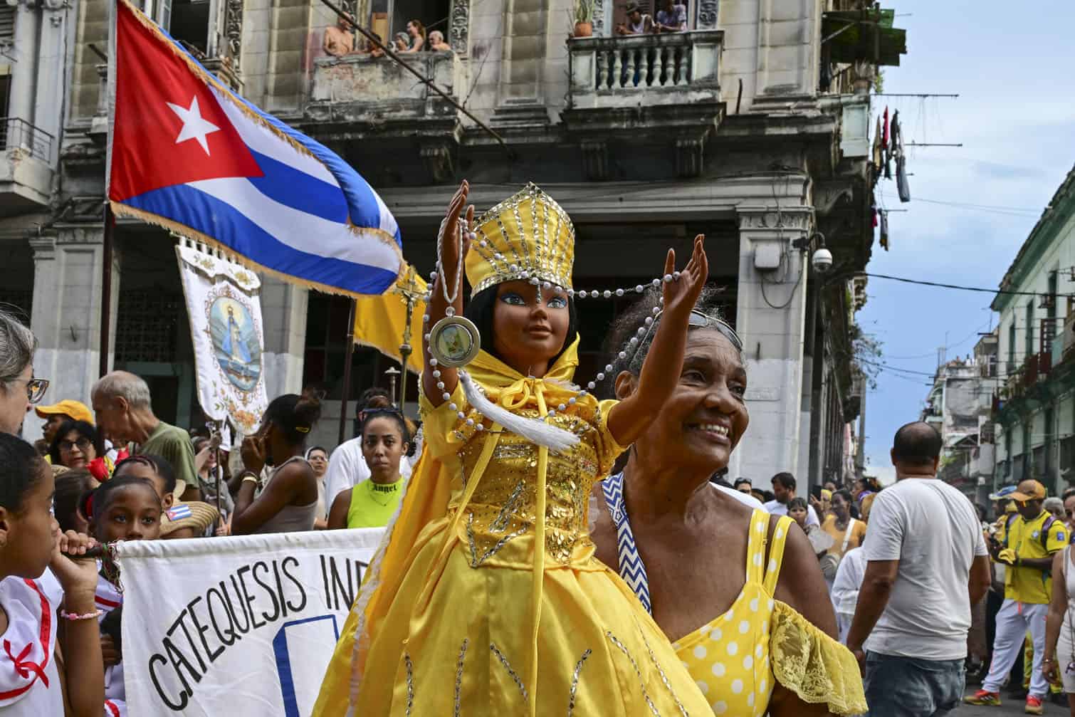 A follower of the Virgin of Charity, Oxun in the Yoruba religion, carries a doll as she takes part in a procession during the Oxun Day celebrations in Havana on September 8, 2026. (Photo by YAMIL LAGE / AFP)