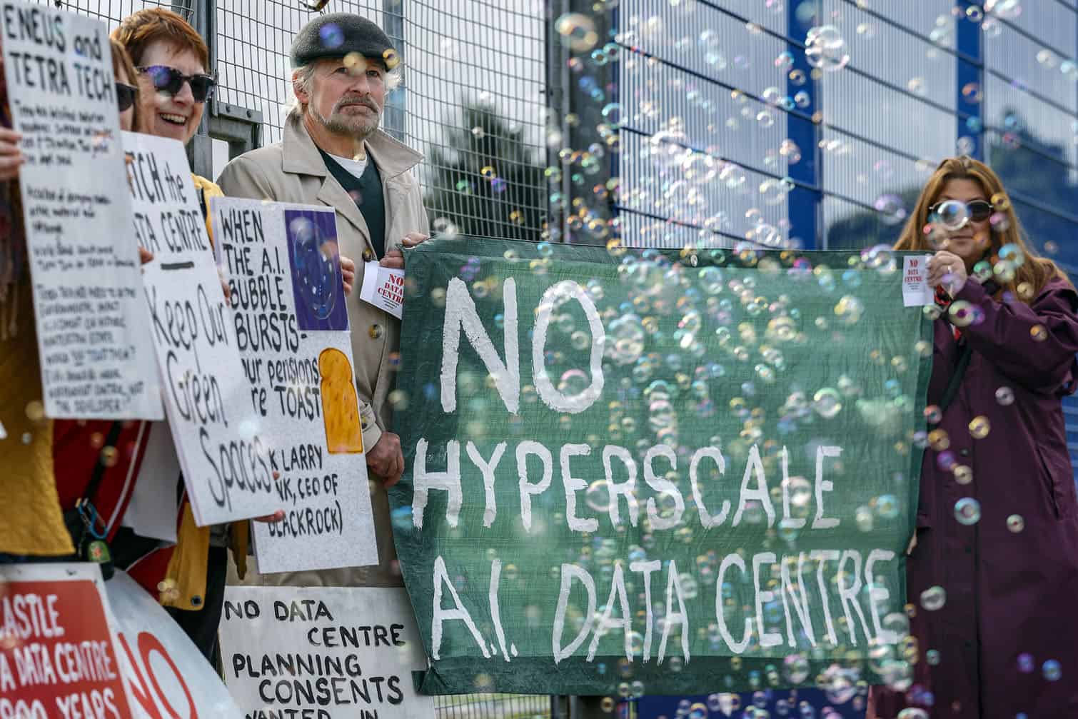 Community campaigners demonstrating against a proposed large-scale data centre rally outside the Park Hotel, where a B2B event attended by representatives from Eneus Energy is taking place on September 30, 2026 in Kilmarnock, Scotland. Demonstrators from the Reject Hunterston Data Centre Campaign Group and the Hurlford Rufus Data Centre Group are protesting Eneus Energy's proposal to build a large-scale data centre campus in Hunterston, North Ayrshire, raising concerns over the development's potential impact on the local environment and resources. (Photo by Jeff J Mitchell/Getty Images)