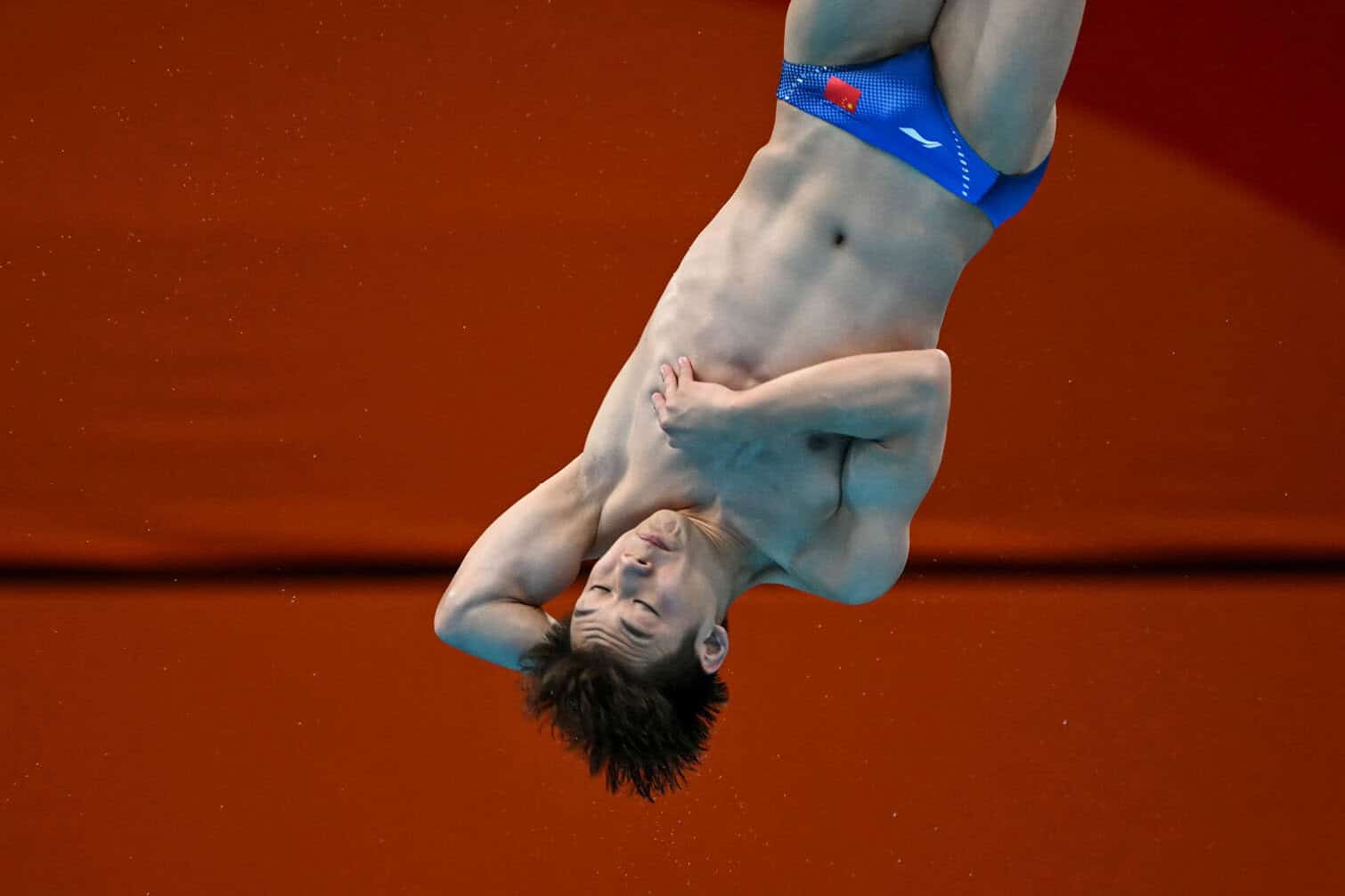 China's Zheng Jiuyuan competes in the men's 3m springboard final diving event during the 2026 Asian Games at the Tokyo Aquatics Centre in Tokyo on September 29, 2026. (Photo by ANDREW CABALLERO-REYNOLDS / AFP)