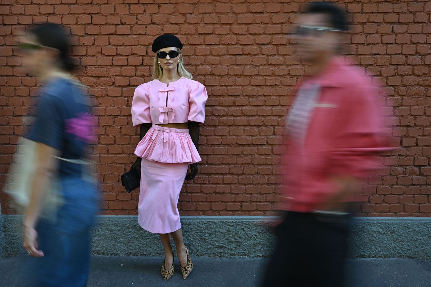 A guest poses in the street outside the Fendi collection show during the Women's Spring/Summer 2027 Milan's fashion week, on September 23, 2026. (Photo by PIERO CRUCIATTI / AFP)