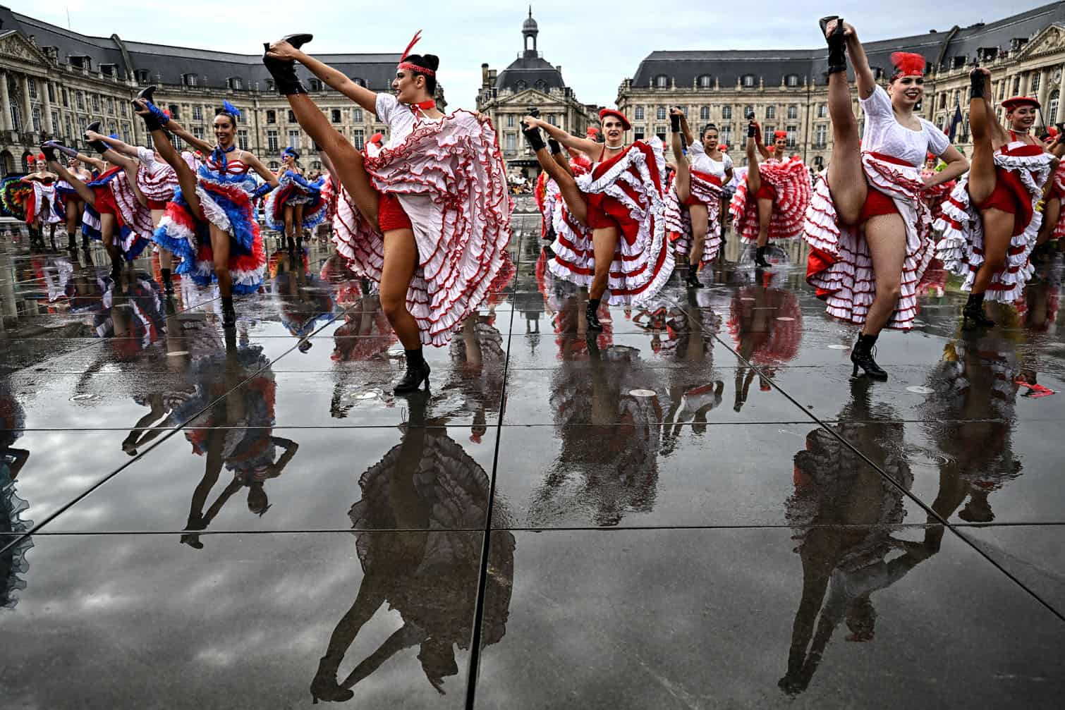 Dancers perform during an attempt to break the world record for the highest number of participants in a French Cancan performance, above the Mirroir d'Eau (Water Mirror) reflecting pool in Bordeaux, south-western France on September 30, 2026. (Photo by Christophe ARCHAMBAULT / AFP)