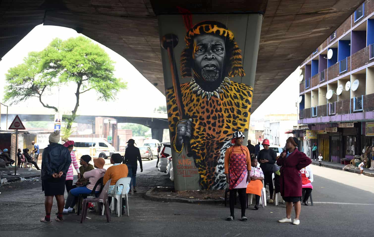 Kwa Mai Mai Traditional Market food stall traders work beside a mural of the late King Goodwill Zwelithini kaBhekuzulu beneath an elevated highway overpass near Johannesburg’s Maboneng Precinct, 28 September 2026. Picture: Nigel Sibanda/The Citizen